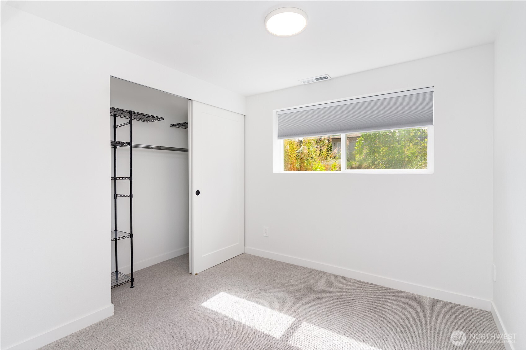 8428 Northeast 132nd Place Kirkland, WA 98034 - Photo 26 of 30 an empty room with a window and a bathroom