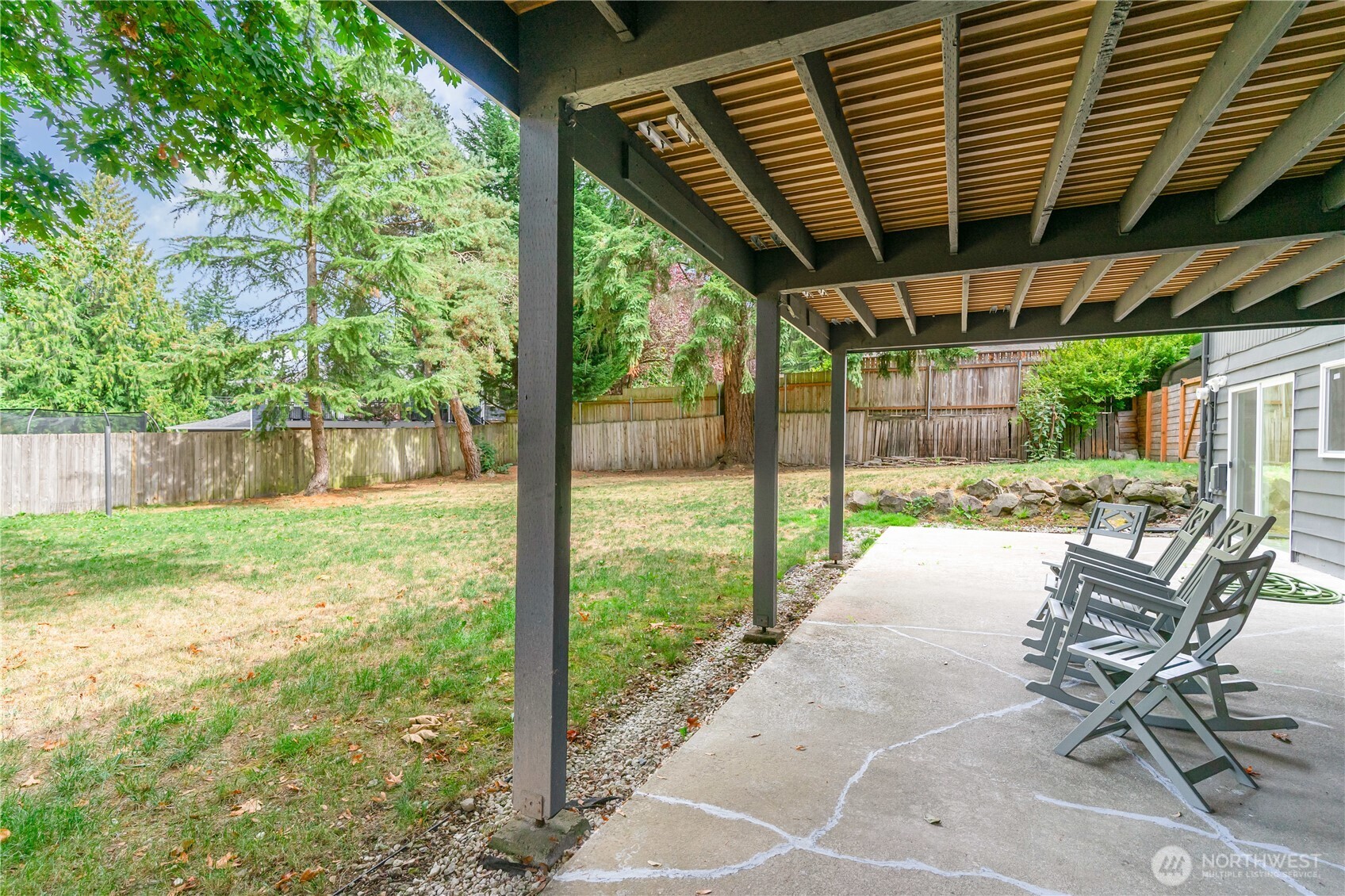 8428 Northeast 132nd Place Kirkland, WA 98034 - Photo 30 of 30 a view of a patio with table and chairs and floor to ceiling window