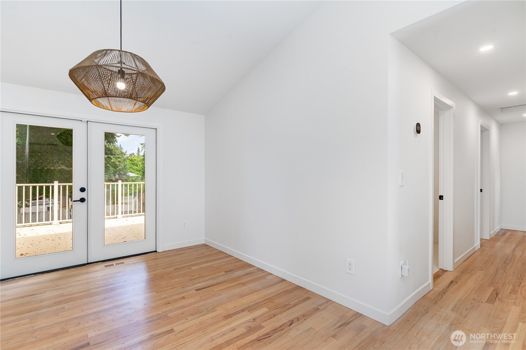 8428 Northeast 132nd Place Kirkland, WA 98034 - Photo 7 of 30 a view of an empty room with wooden floor and window
