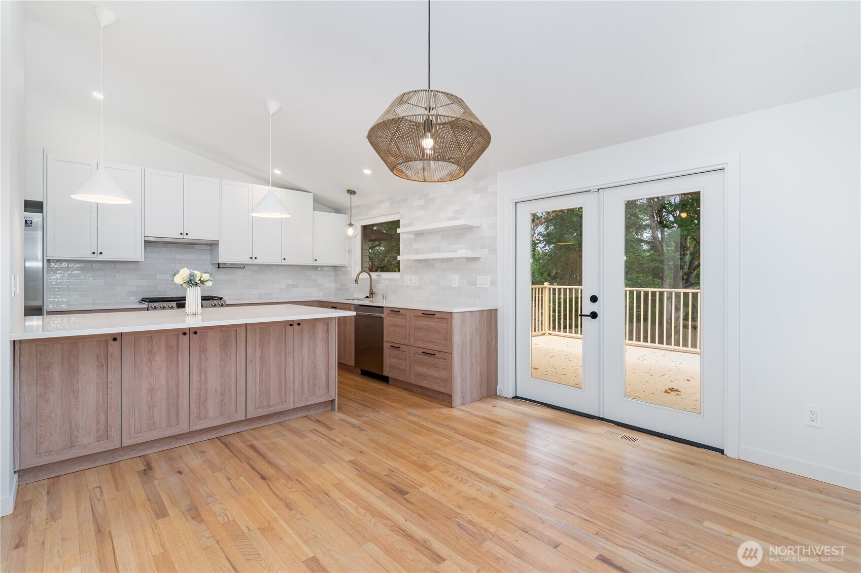 8428 Northeast 132nd Place Kirkland, WA 98034 - Photo 8 of 30 a kitchen with stainless steel appliances granite countertop a sink a microwave oven a stove and white cabinets with wooden floor