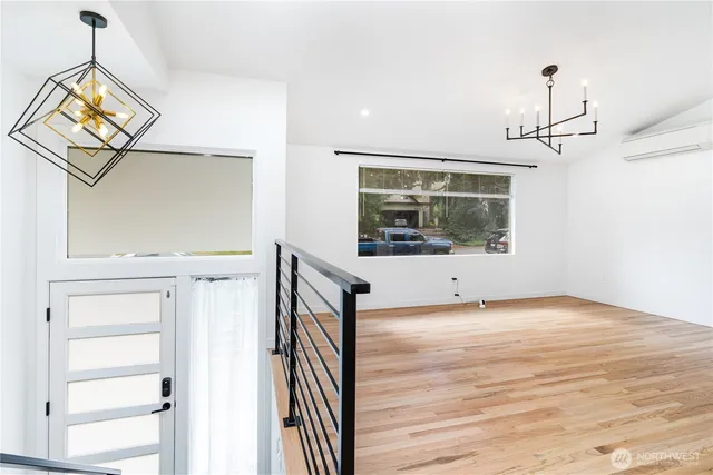 a view of a hallway with entryway wooden floor and front door