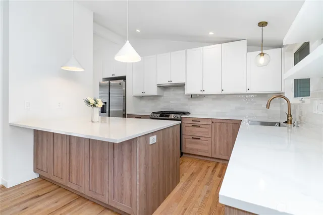 a kitchen with granite countertop a sink stove and cabinets