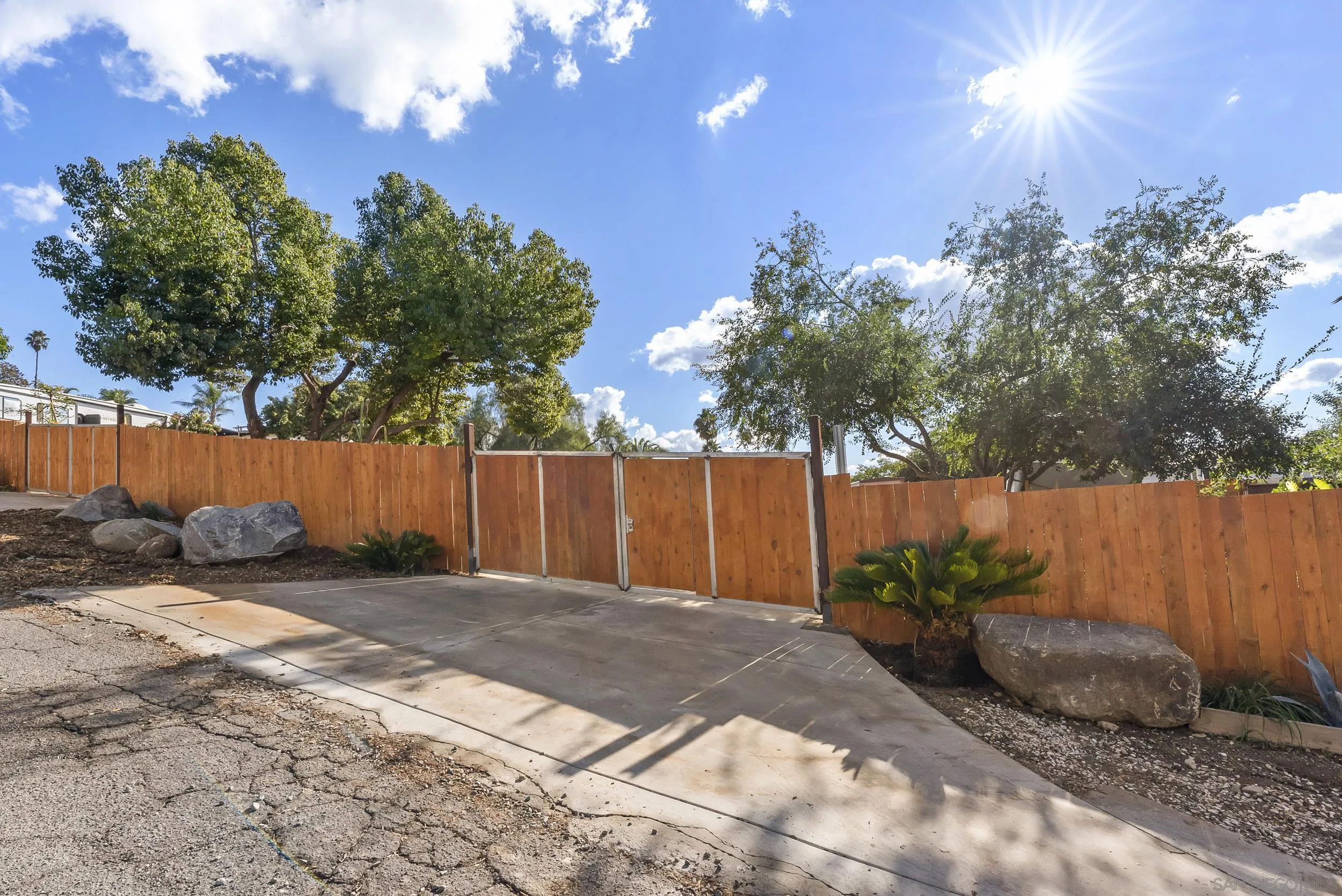 0 Park Hill Drive, Unit 24 Escondido, CA 92025 - Photo 17 of 28 a view of backyard with potted plants and wooden fence
