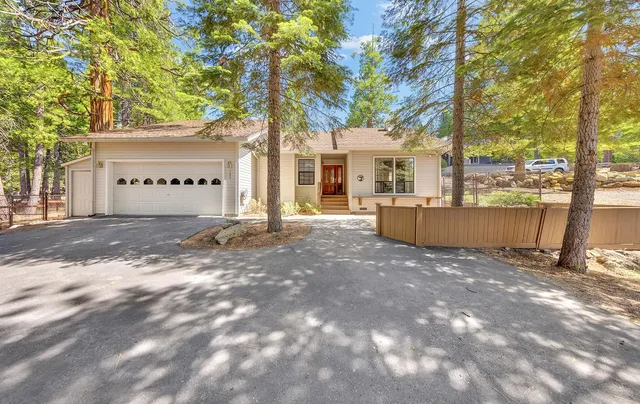 a view of a house with a tree in front