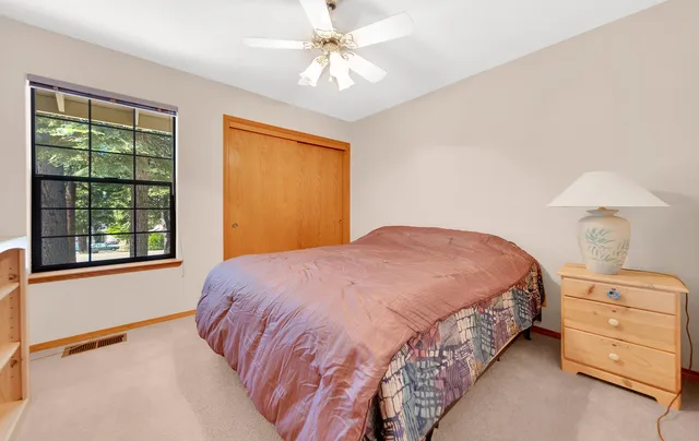 a bedroom with a bed and a window dresser