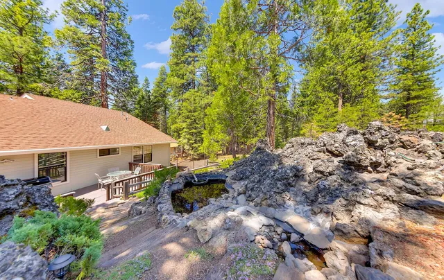 a backyard of a house with table and chairs
