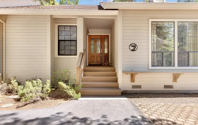 a front view of a house with a garden