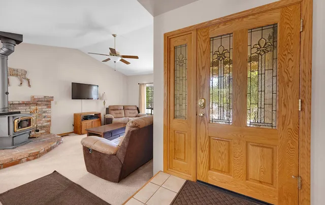 a living room with furniture a flat screen tv and a window