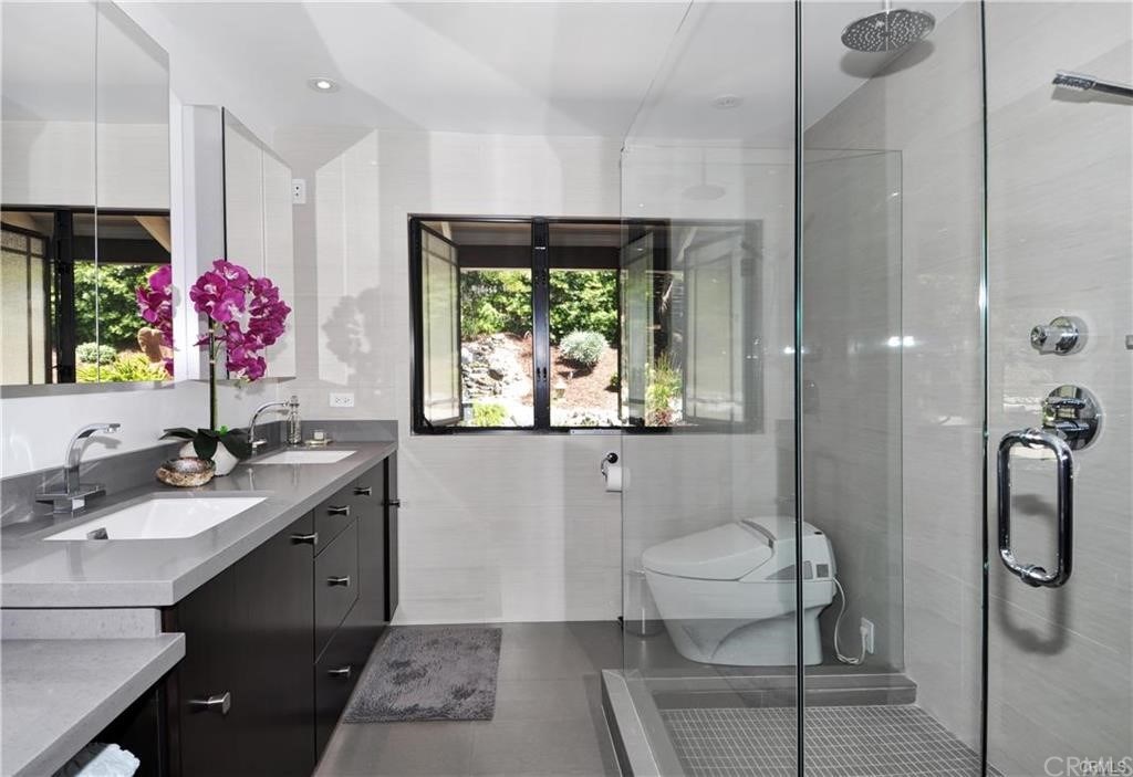 32732 Mediterranean Drive Dana Point, CA 92629 - Photo 15 of 24 a bathroom with a granite countertop sink a toilet a mirror and shower