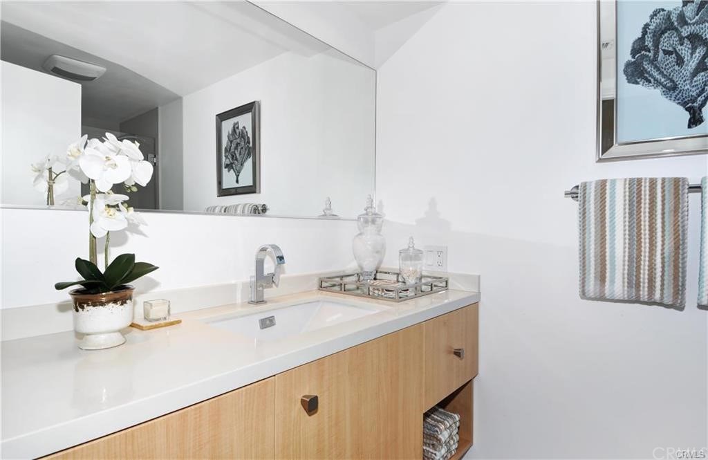 32732 Mediterranean Drive Dana Point, CA 92629 - Photo 17 of 24 a bathroom with a sink a mirror and a potted plant