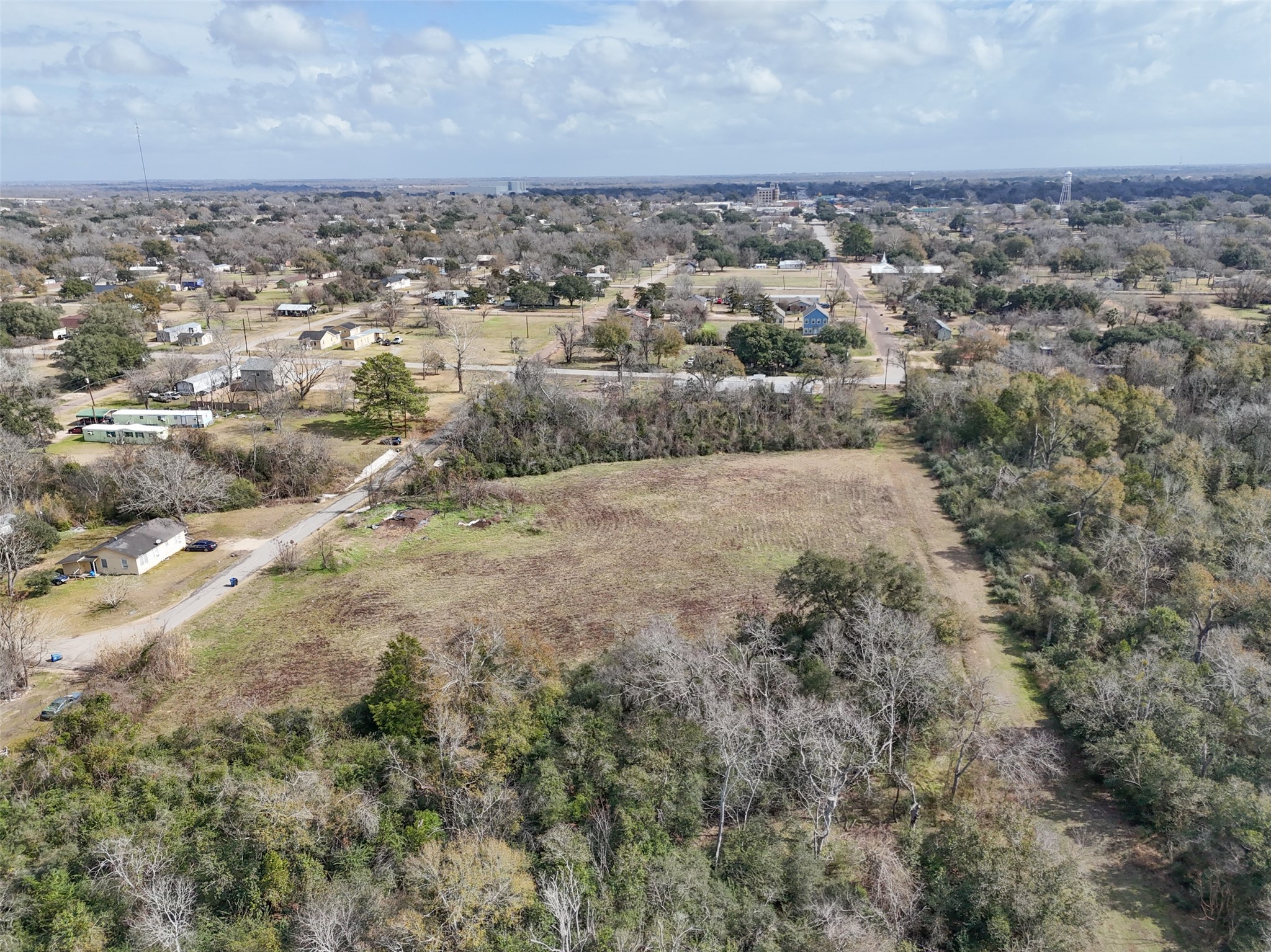Tbd Tbd 22nd Hempstead, TX 77445 - Photo 11 of 20 An expanded aerial look emphasizes the cleared field framed by wooded perimeter areas, providing both openness and natural buffering.