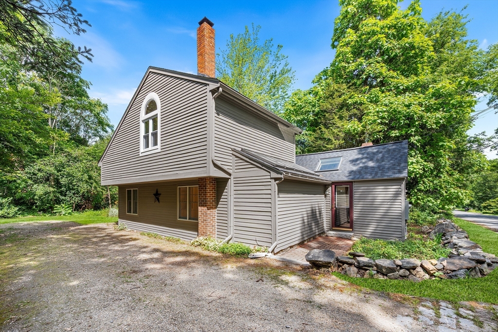 44 East Bare Hill Road Harvard, MA 01451 - Photo 2 of 20 a front view of a house with a yard and garage