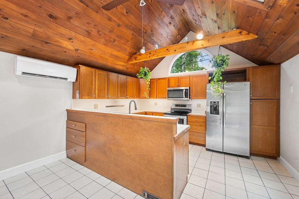 44 East Bare Hill Road Harvard, MA 01451 - Photo 9 of 20 a kitchen with stainless steel appliances kitchen island granite countertop a refrigerator and a stove