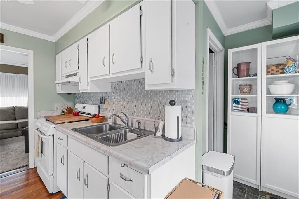1038 Summit Avenue Monaca, PA 15061 - Photo 11 of 23 a kitchen with stainless steel appliances granite countertop a sink stove and cabinets