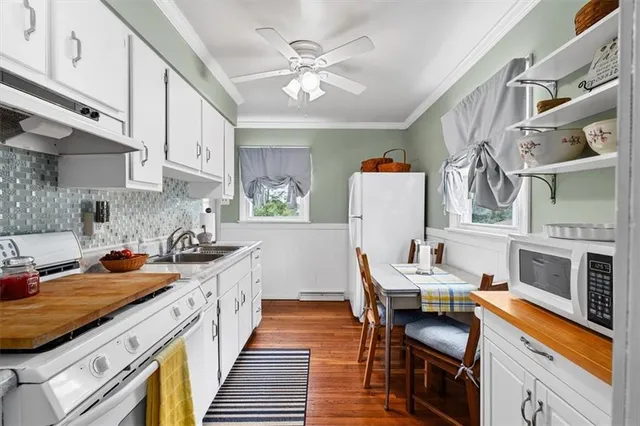 a kitchen with cabinets and wooden floor