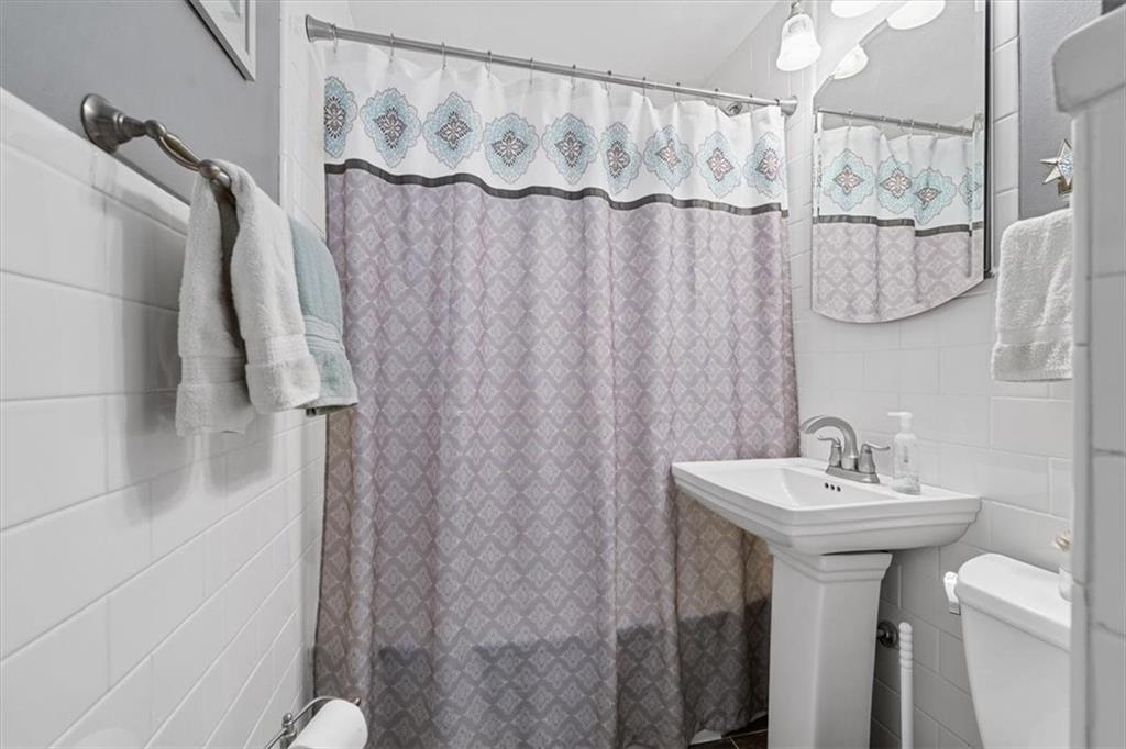 1038 Summit Avenue Monaca, PA 15061 - Photo 13 of 23 a bathroom with a sink a mirror and a shower curtain