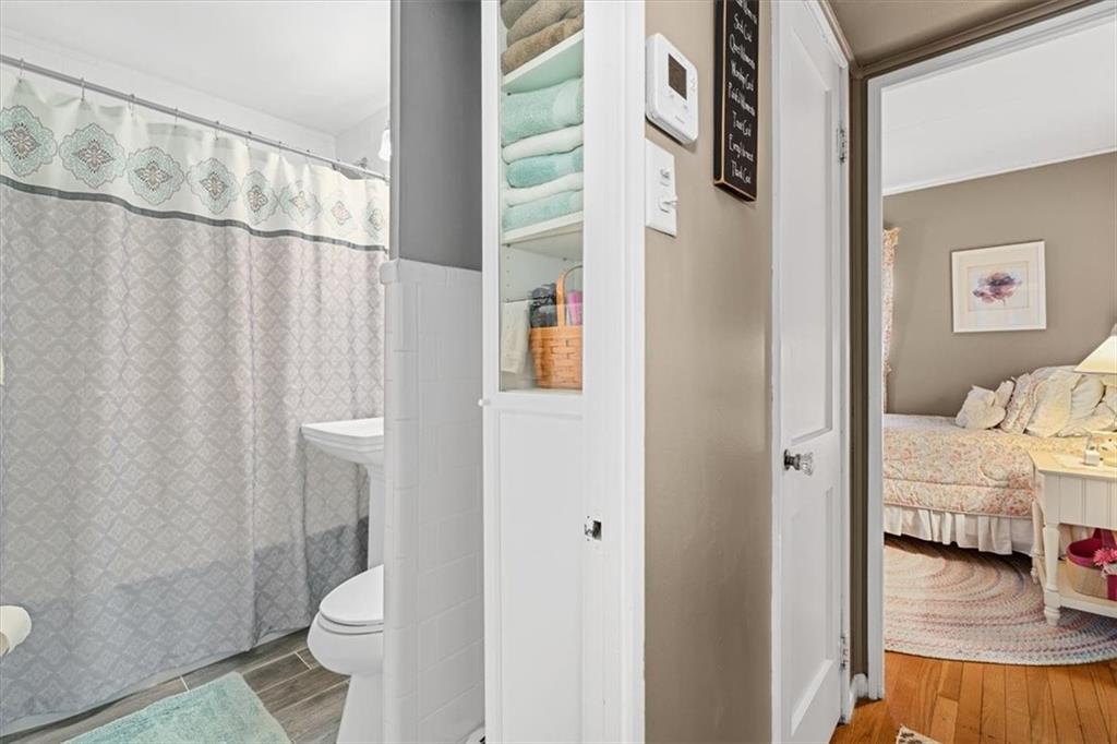 1038 Summit Avenue Monaca, PA 15061 - Photo 14 of 23 a bathroom with a toilet and a shower curtain