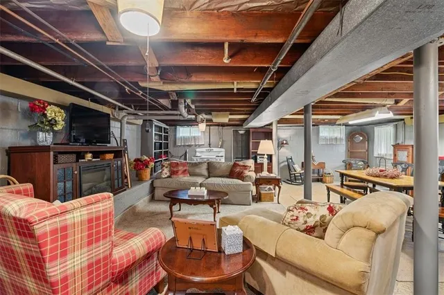 a living room with furniture and a kitchen view