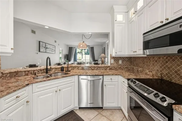 a kitchen with cabinets and stainless steel appliances