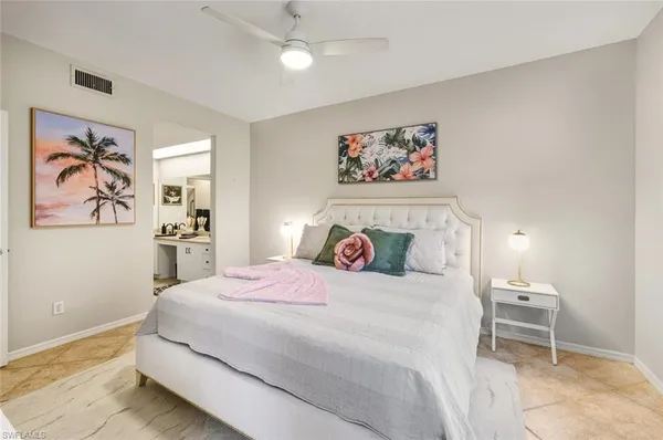 a bedroom with a large bed and a window