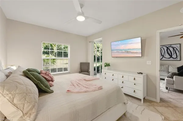 a spacious bedroom with a bed a couch and a bookshelf