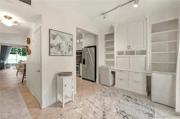 a view of a storage & utility room with refrigerator