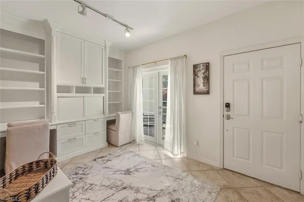 a dining room with furniture a chandelier and wooden floor
