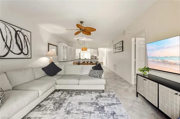 a view of a a dining room with furniture window and wooden floor