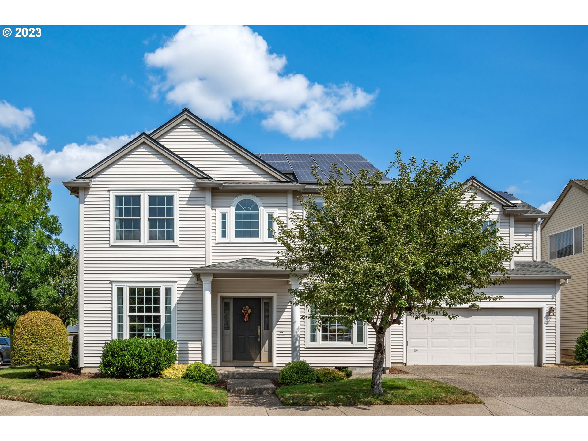 8627 Southwest Lodi Lane Portland, OR 97224 - Photo 1 of 41 a front view of a house with a garden