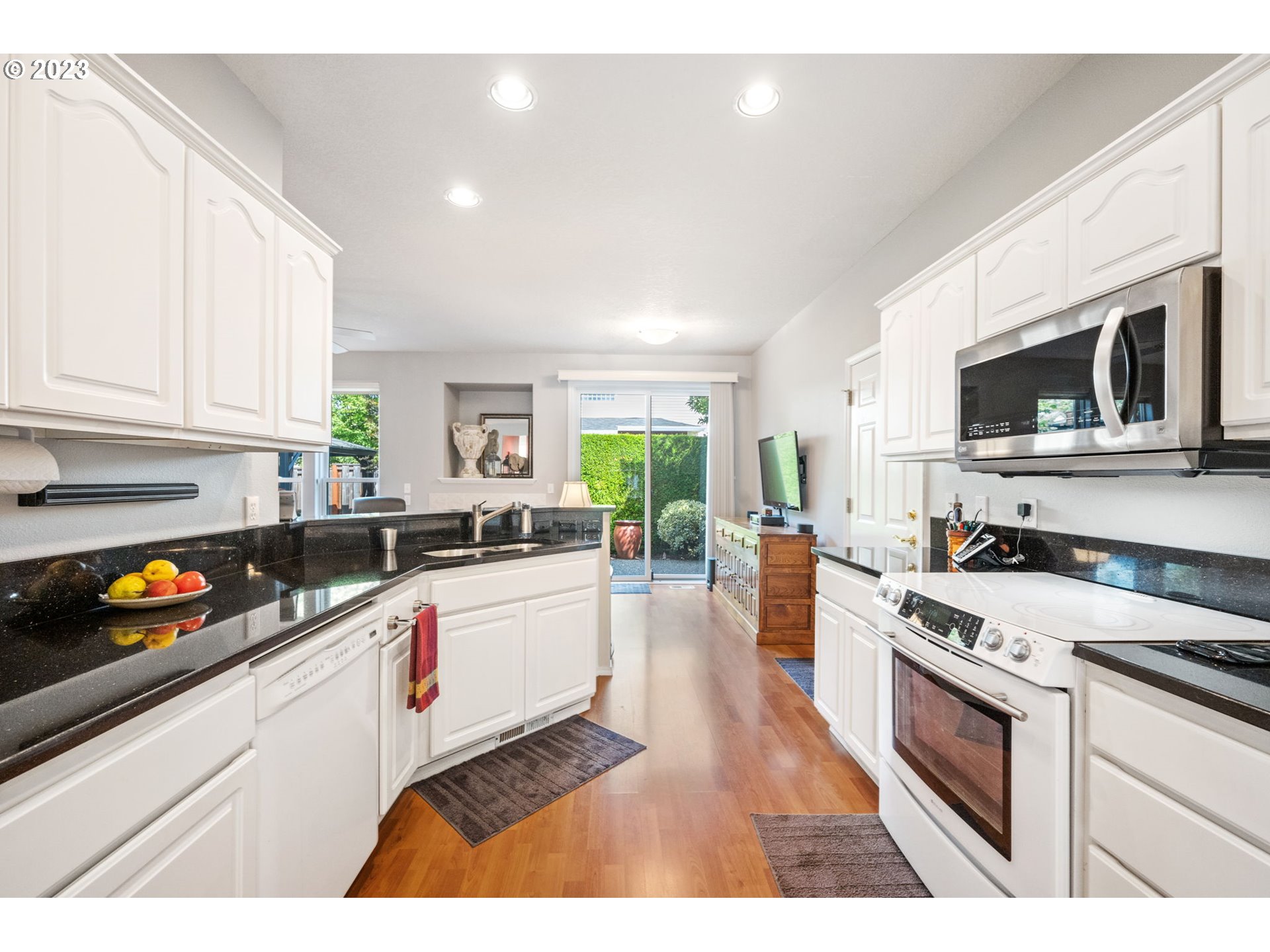 8627 Southwest Lodi Lane Portland, OR 97224 - Photo 11 of 41 a kitchen with stainless steel appliances granite countertop a stove a sink and a microwave