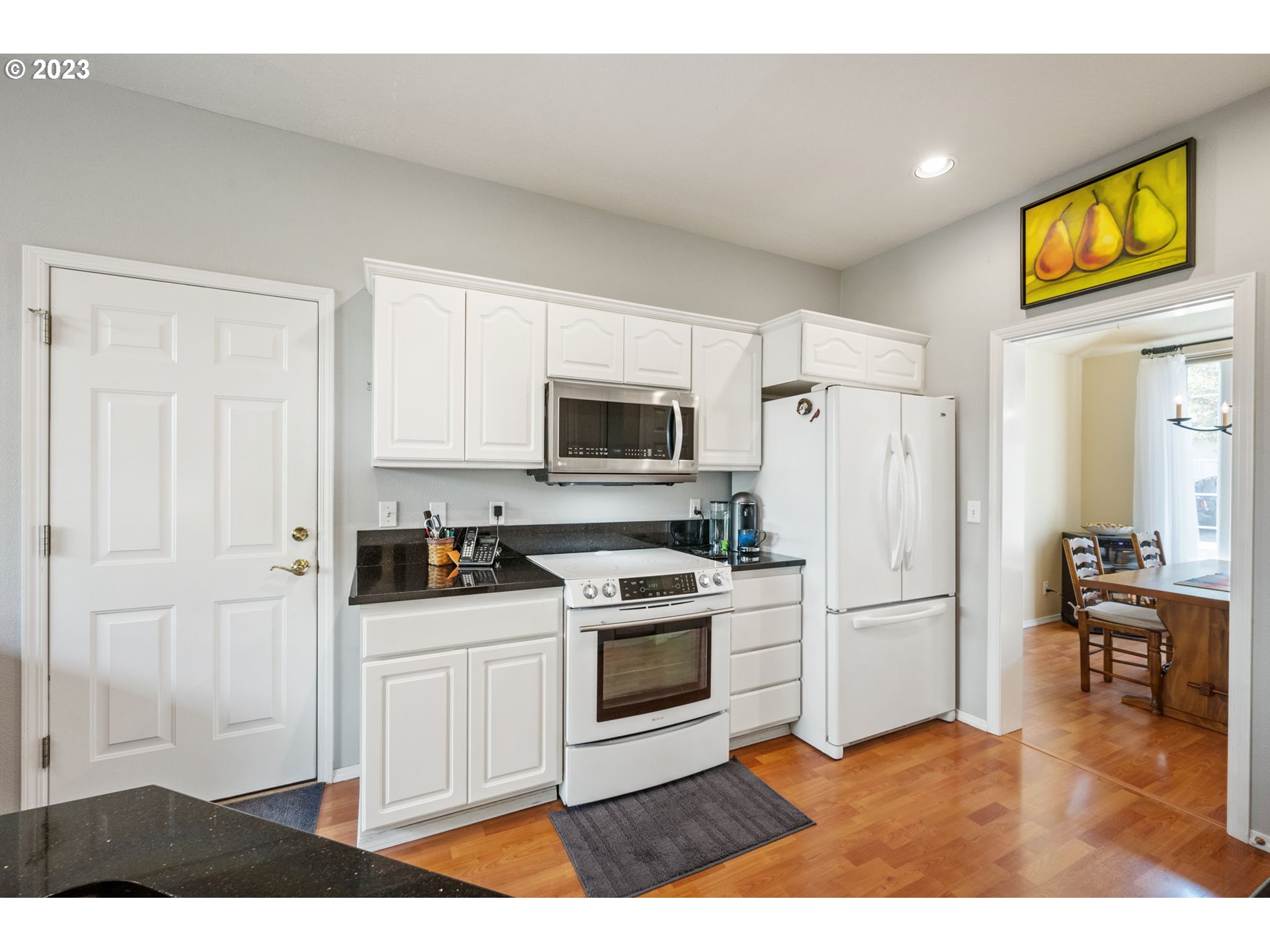 8627 Southwest Lodi Lane Portland, OR 97224 - Photo 12 of 41 a kitchen with a refrigerator and a stove top oven