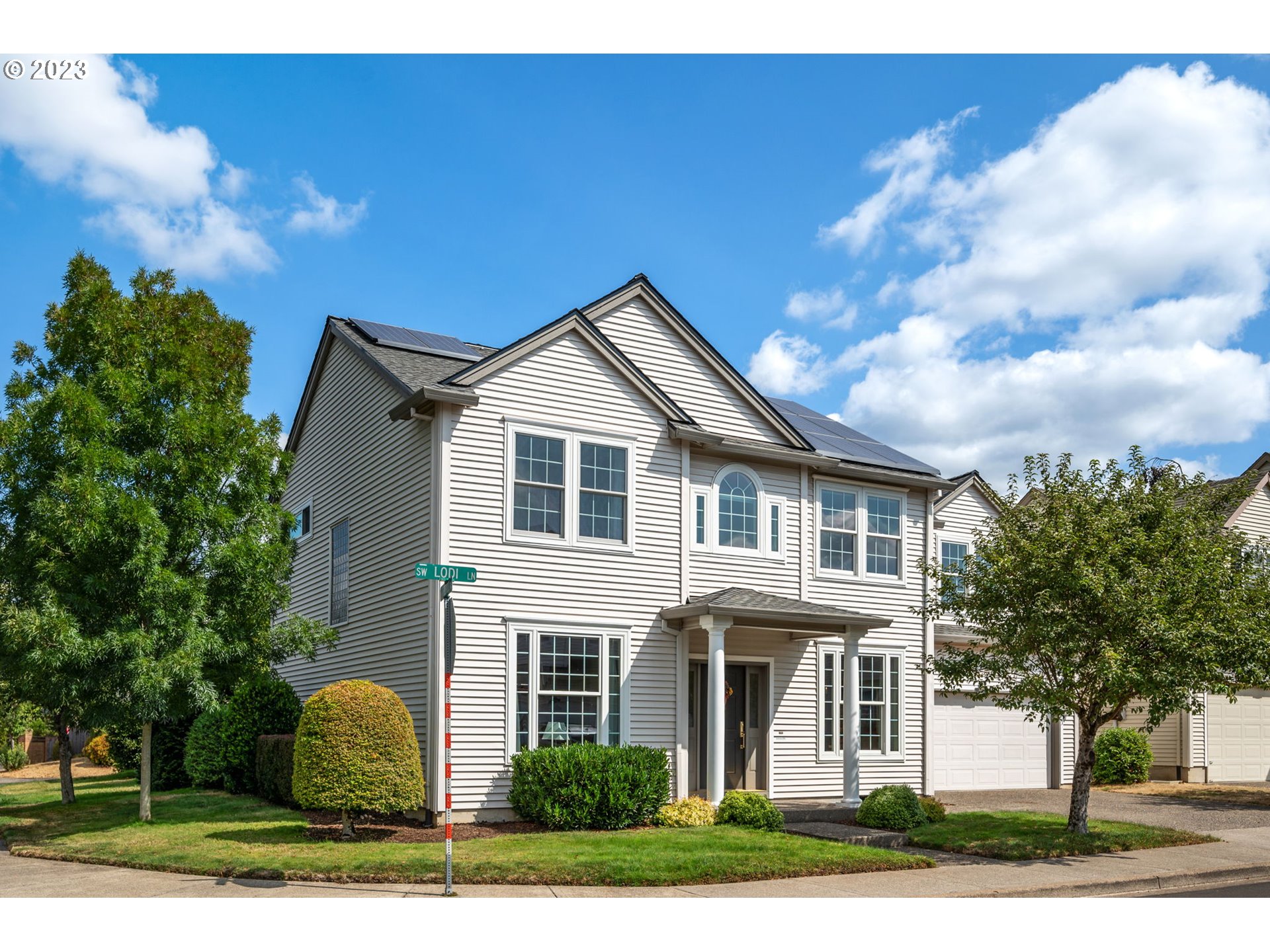 8627 Southwest Lodi Lane Portland, OR 97224 - Photo 2 of 41 a front view of a house with a yard