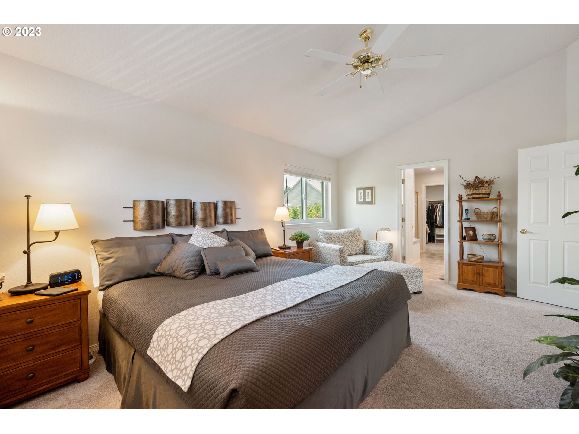 8627 Southwest Lodi Lane Portland, OR 97224 - Photo 22 of 41 a bedroom with a large bed and a chandelier