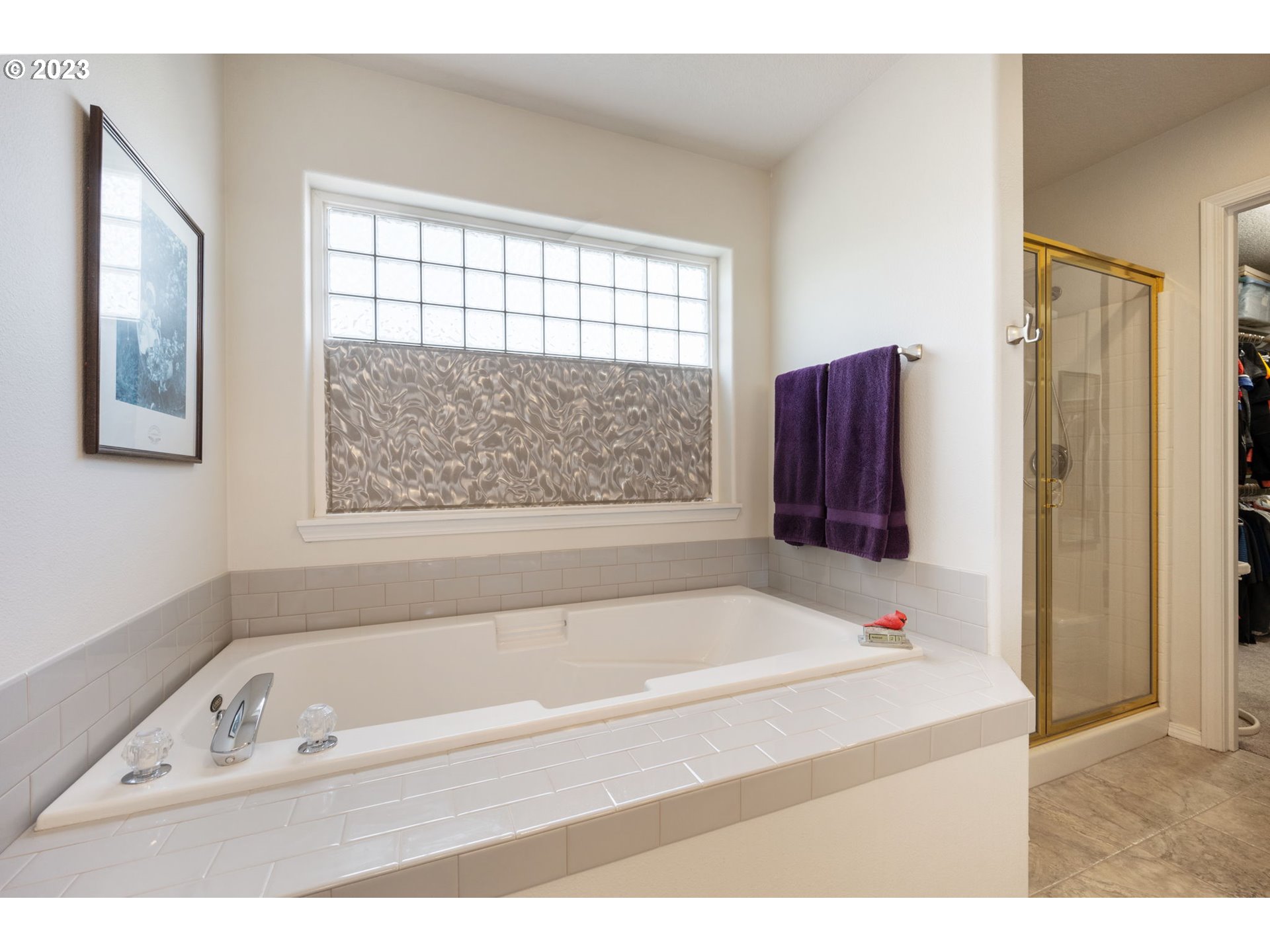 8627 Southwest Lodi Lane Portland, OR 97224 - Photo 24 of 41 a bathroom with a bathtub and a window