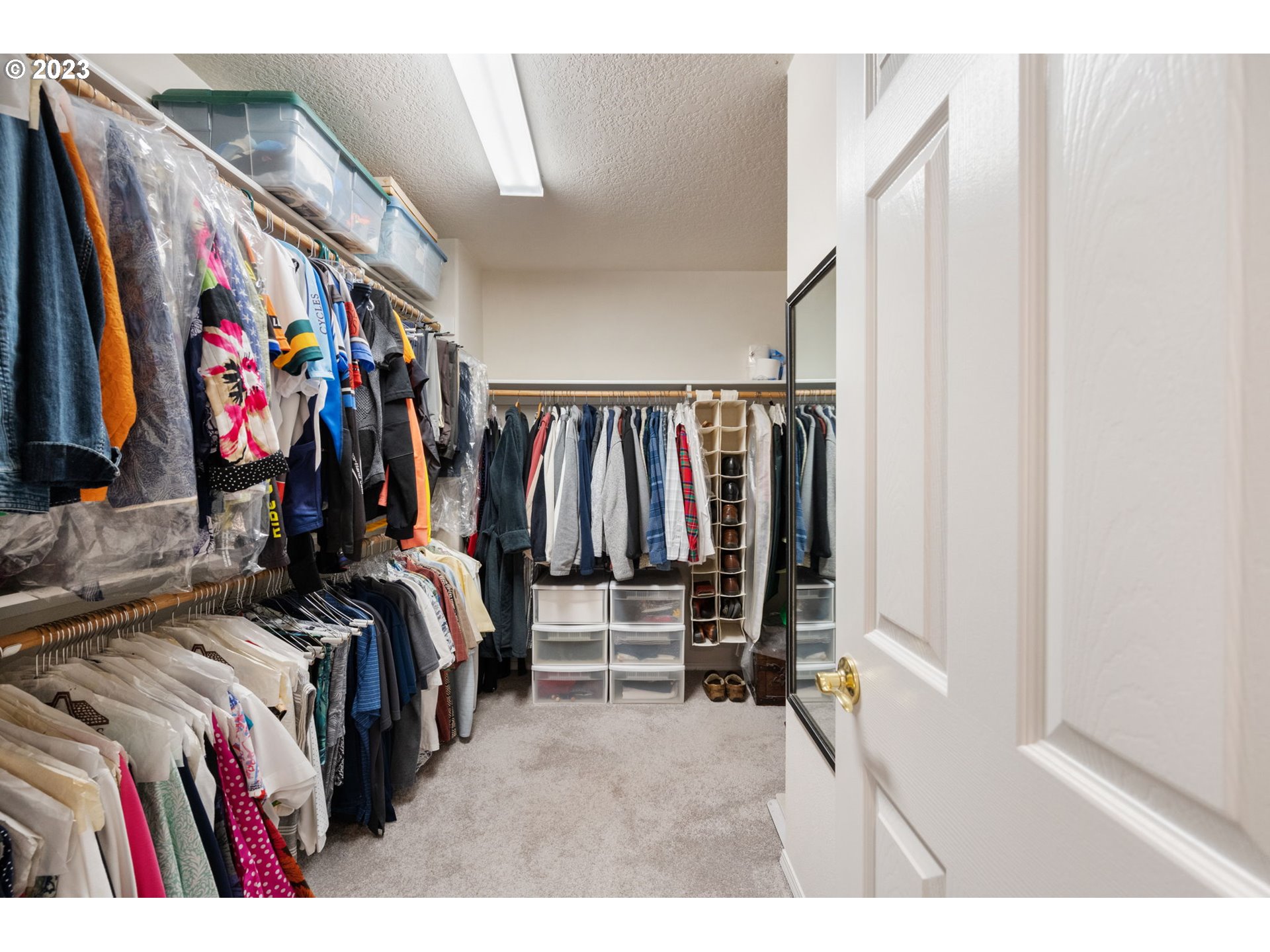 8627 Southwest Lodi Lane Portland, OR 97224 - Photo 25 of 41 a view of walk in closet with clothes and shoes