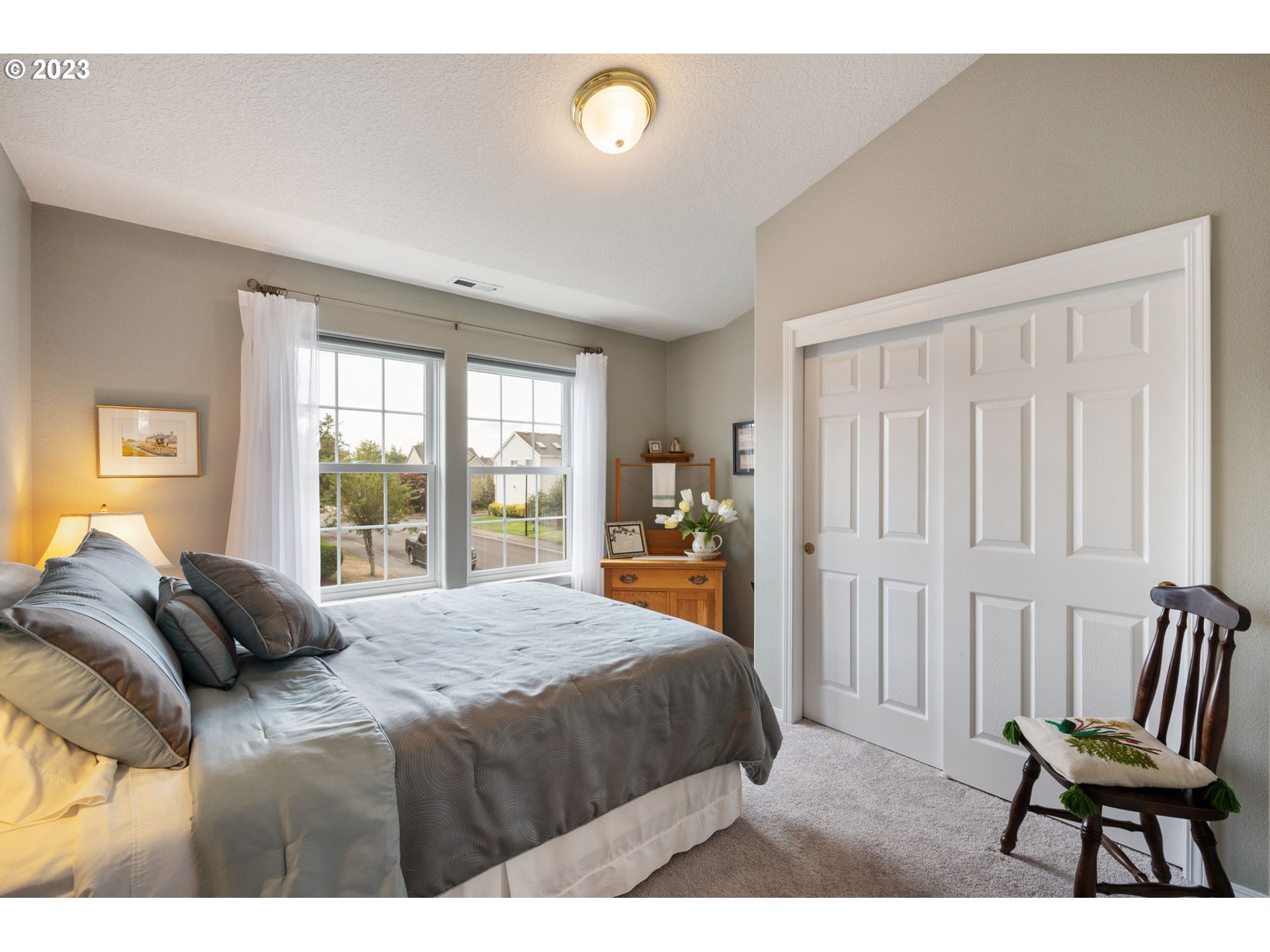 8627 Southwest Lodi Lane Portland, OR 97224 - Photo 26 of 41 a bedroom with a bed and a chair