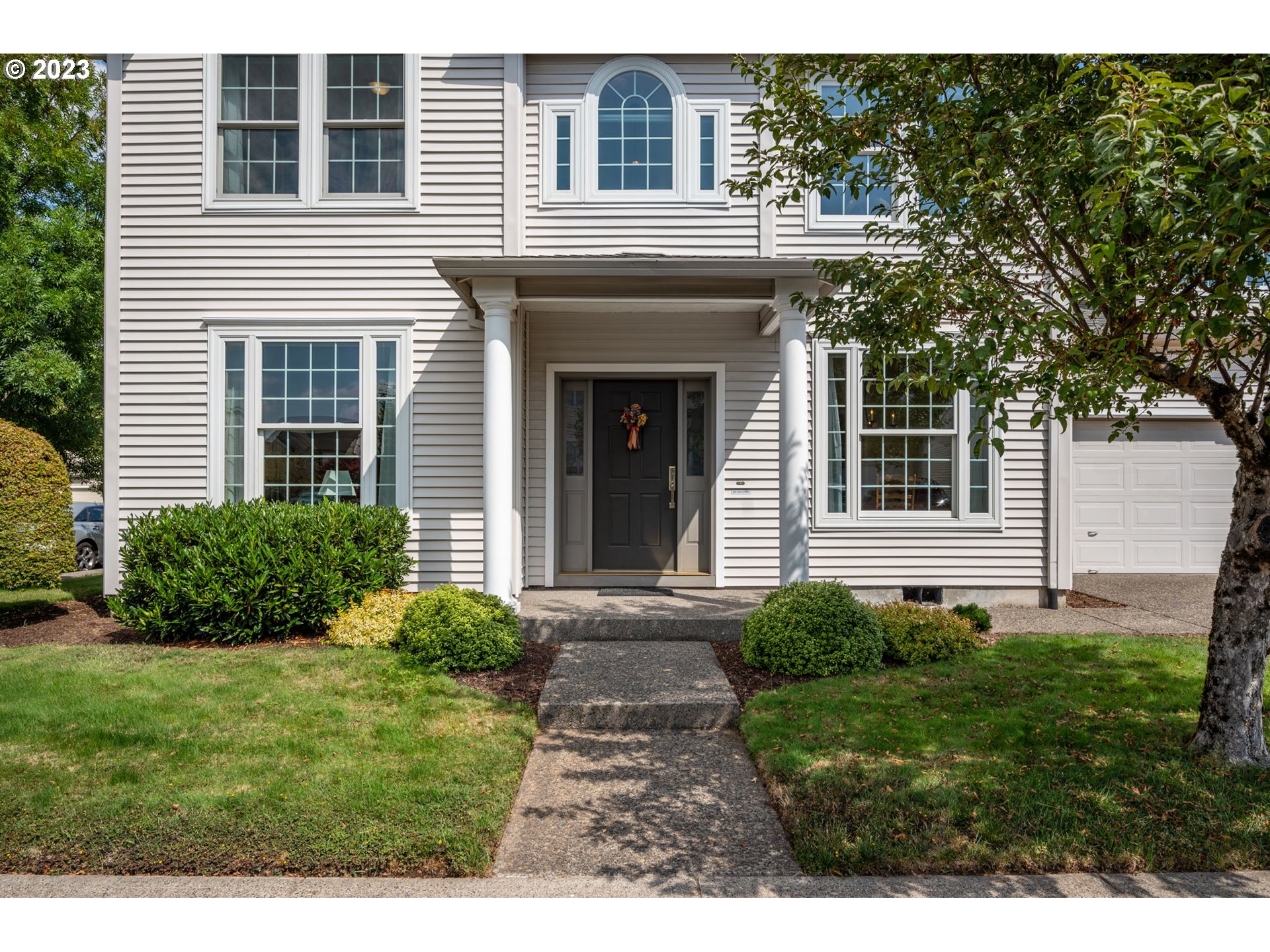 8627 Southwest Lodi Lane Portland, OR 97224 - Photo 4 of 41 a view of a house with a yard and potted plants