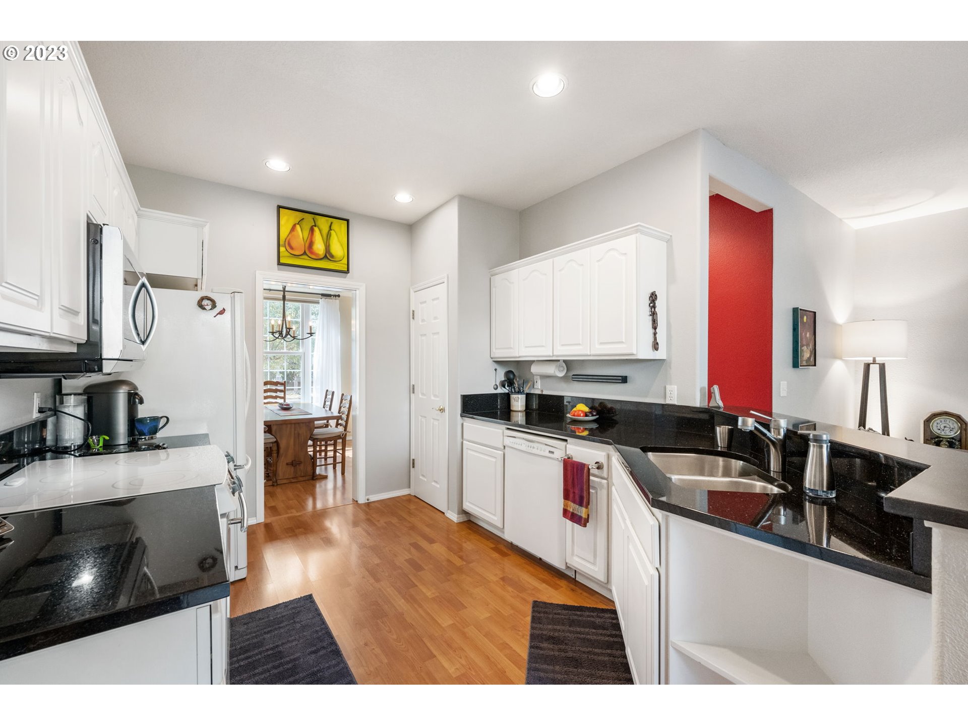 8627 Southwest Lodi Lane Portland, OR 97224 - Photo 10 of 41 a kitchen with stainless steel appliances granite countertop a sink stove and cabinets