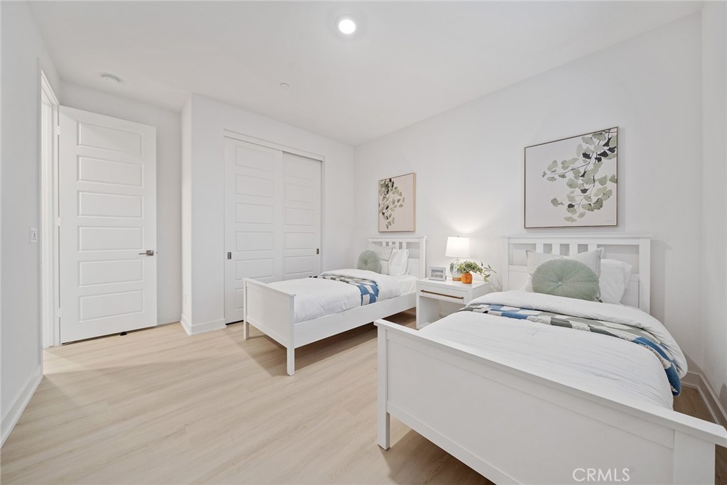 131 Restore Irvine, CA 92618 - Photo 20 of 43 a spacious bedroom with a bed and wall painting