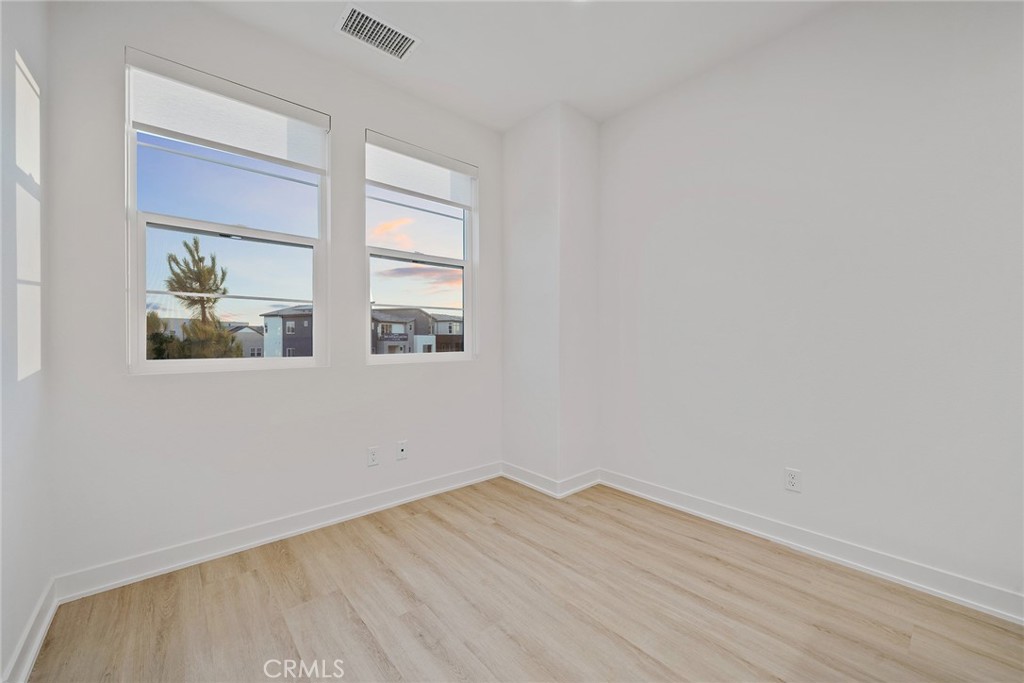 131 Restore Irvine, CA 92618 - Photo 25 of 43 a view of empty room with wooden floor and fan