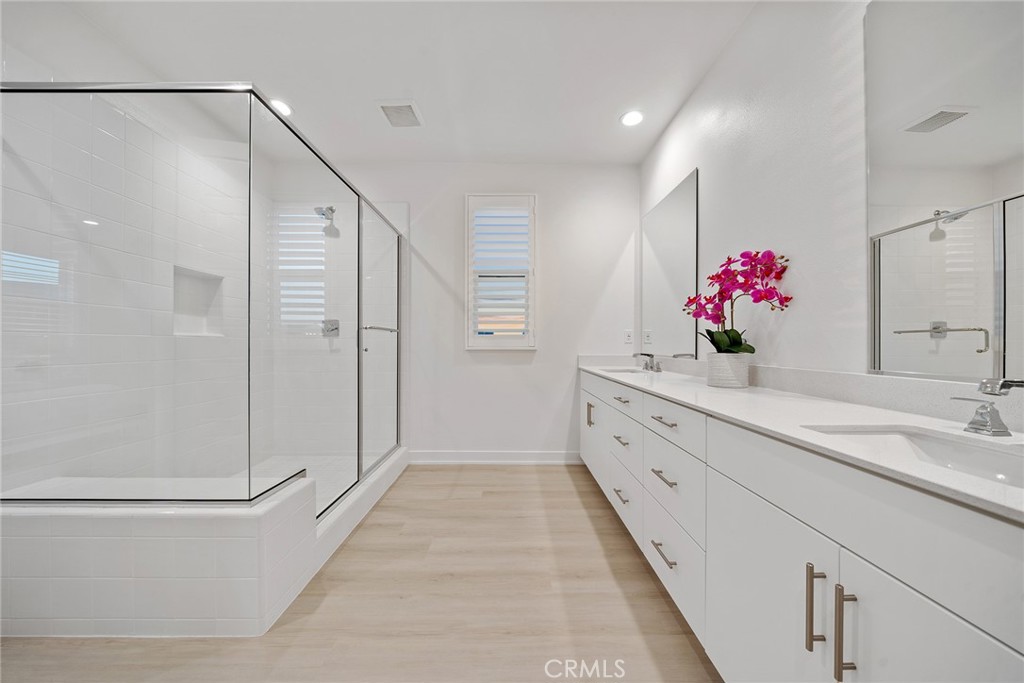 131 Restore Irvine, CA 92618 - Photo 29 of 43 a bathroom with a double vanity sink mirror and shower