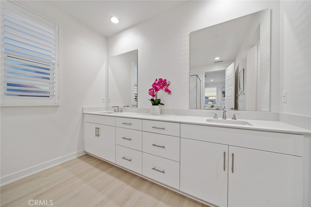 131 Restore Irvine, CA 92618 - Photo 30 of 43 a bathroom with a granite countertop double vanity sink and a mirror