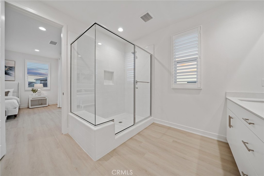 131 Restore Irvine, CA 92618 - Photo 31 of 43 a spacious bathroom with a glass shower door and a window