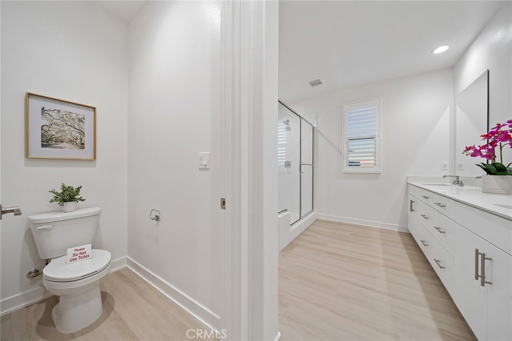 131 Restore Irvine, CA 92618 - Photo 32 of 43 a bathroom with a sink mirror vanity and toilet