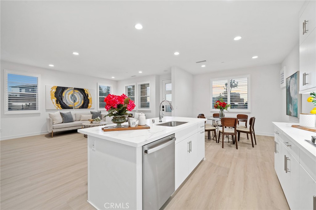 131 Restore Irvine, CA 92618 - Photo 7 of 43 a kitchen that has a lot of white cabinets and wooden floor