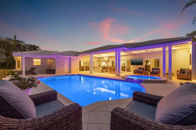 a view of a kitchen with refrigerator and white cabinets