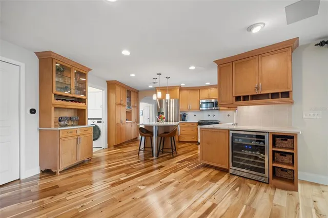 a dining room with furniture and a floor to ceiling window