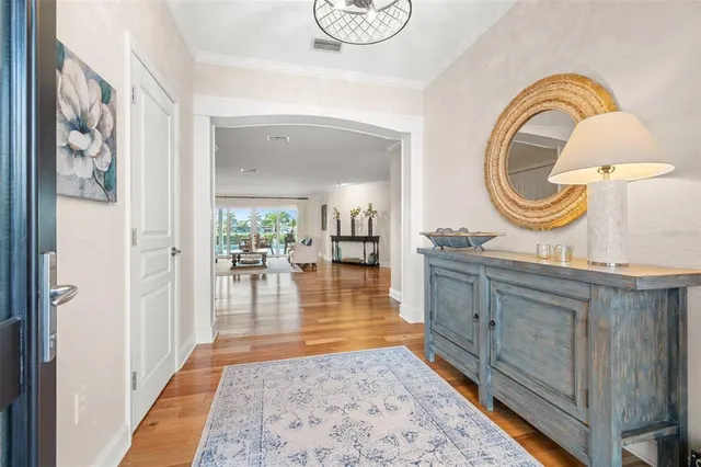 a kitchen with stainless steel appliances granite countertop a stove a sink dishwasher and a refrigerator with wooden floor