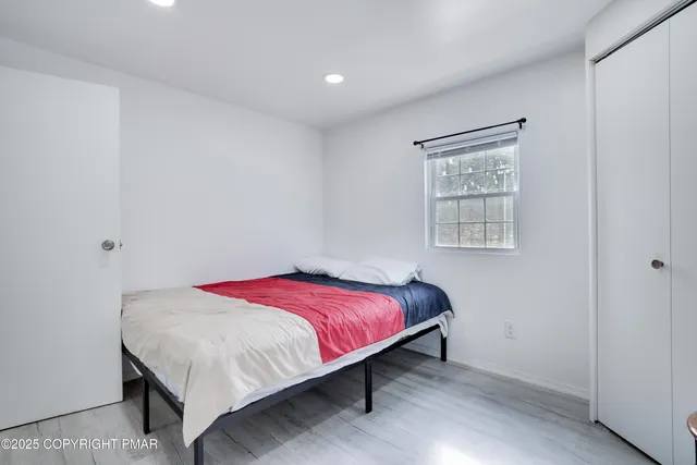 a bedroom with a bed and a window