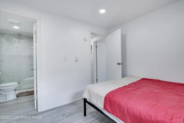 a bedroom with a bed and a toilet